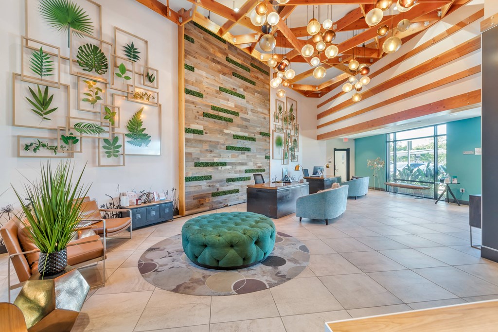 the lobby of a hotel with a reception area and plants on the wall at Metro Gateway, Riverside, CA