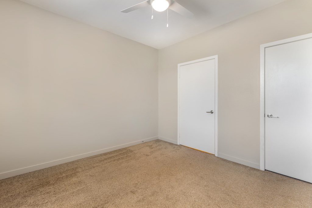 an empty room with white walls and a ceiling fan at Metro Gateway, Riverside