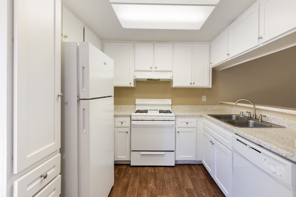 a kitchen with white appliances and white cabinets