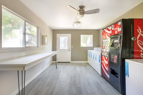 a kitchen with a coke refrigerator and a counter and a window