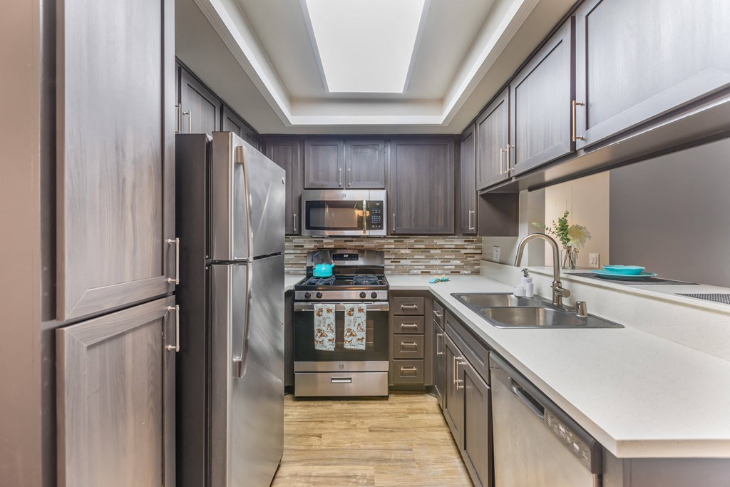 a kitchen with stainless steel appliances and wooden cabinets