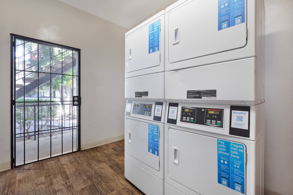 a row of white appliances in a room with a glass door