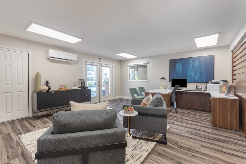 a living room with a couch and a coffee table and a desk