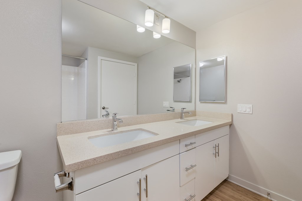 a bathroom with two sinks and a large mirror at Metro Gateway, California