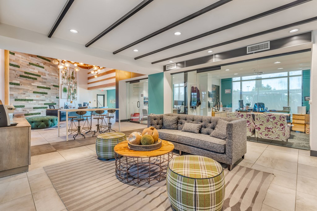 a living room with couches and tables and a kitchen in the background at Metro Gateway, Riverside, California