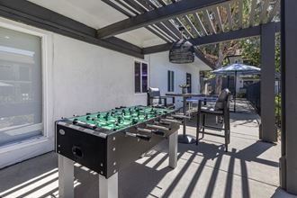 Covered area with foosball and sitting area.