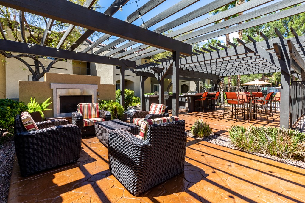 Apartments Near Red Rock - Aviara - Pool side with outdoor furniture, wooden gazebo, and nearby grilling station