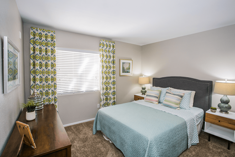 The guest bedroom at Aviara Apartment Homes features fresh paint and updated carpeting, creating a modern and inviting atmosphere for guests to relax and unwind in comfort.