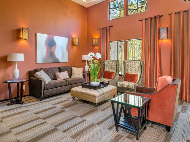 a living room with couches and chairs and a table