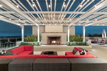 Westwood Luxury Apartments Wilshire Victoria Rooftop Resident Lounge Couch Fireplace evening dusk4 Westwood Luxury Apartments Wilshire Victoria Rooftop Resident Lounge Couch Fireplace evening dusk4