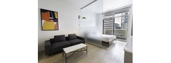 a bedroom with a bed and a couch in a room