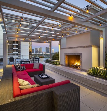Westwood Luxury Apartments Wilshire Victoria Rooftop Resident Lounge Couch Fireplace evening dusk2