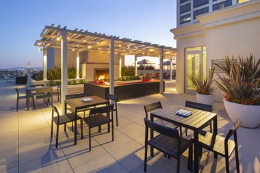 Westwood Luxury Apartments Wilshire Victoria Rooftop Resident Lounge Couch Fireplace evening dusk3 - Photo Gallery 3