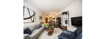 a living room with a gray couch and a coffee table