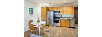 a kitchen with stainless steel appliances and wooden cabinets