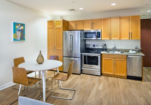 a kitchen with stainless steel appliances and wooden cabinets