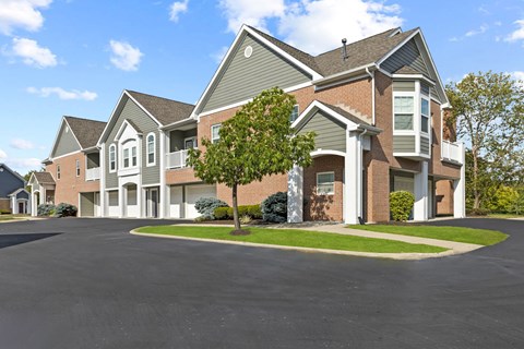 A large house with a driveway in front.
