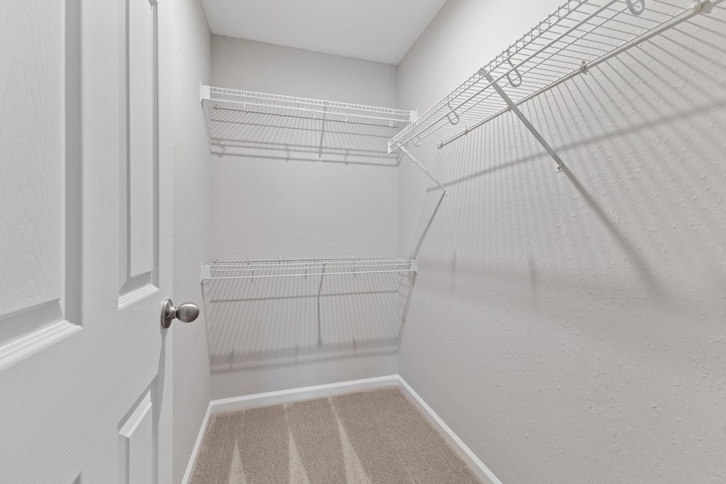 Spacious walk-in closets with shelves for extra storage space