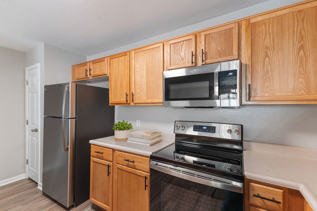 Hard wood cabinets with Stainless Steel Appliances and Flat Top Stove