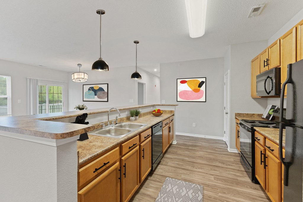 a spacious kitchen with pendant lighting