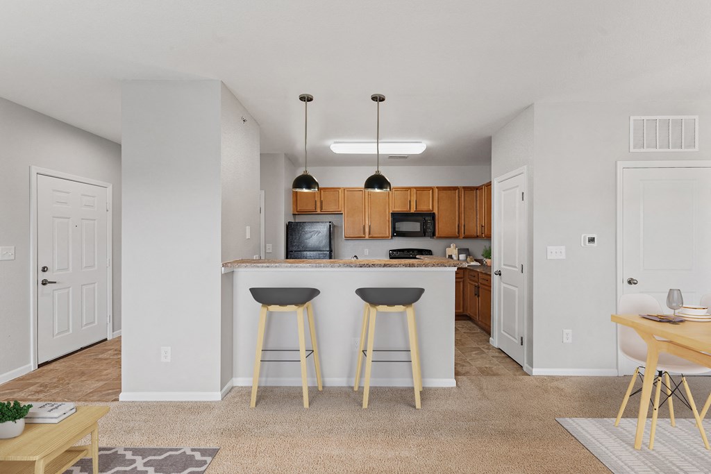 a kitchen with a breakfast bar and stools