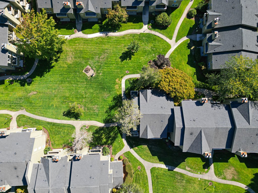 an aerial view of a neighborhood with houses and green grass