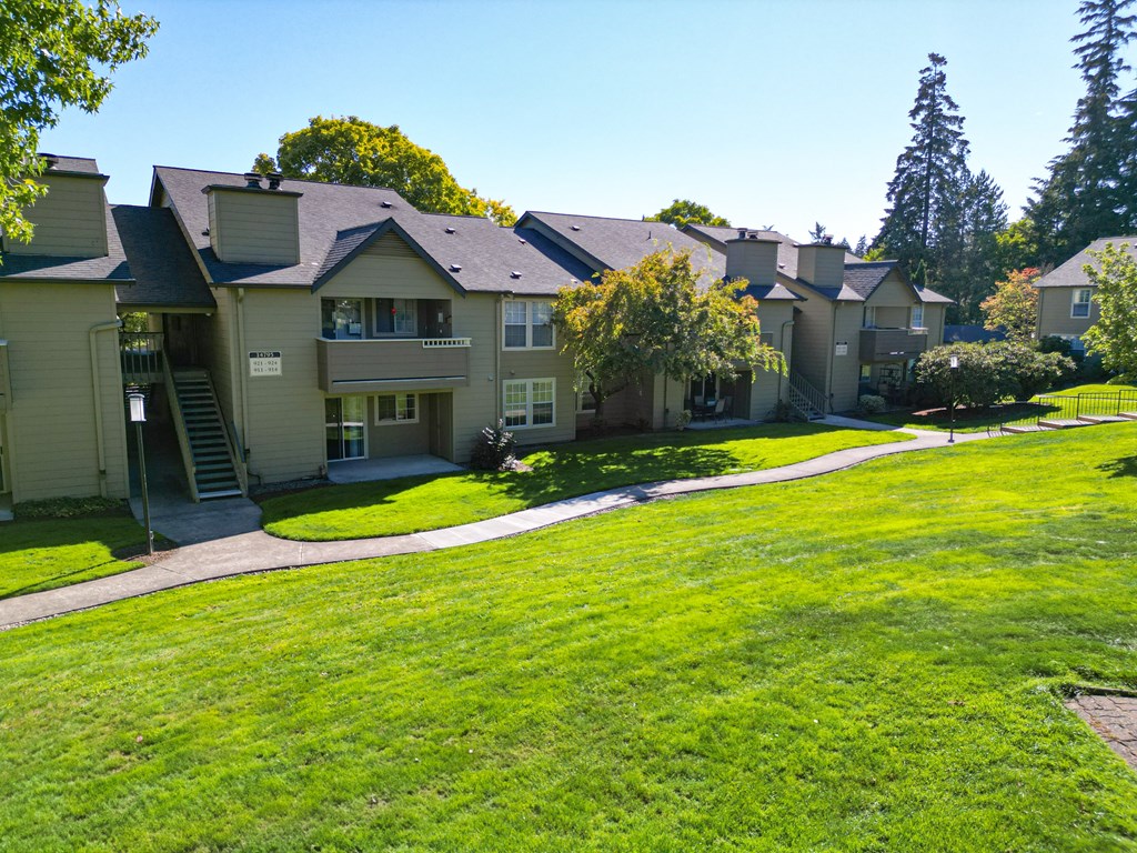 a row of houses on a green lawn