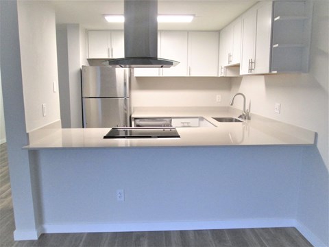 a kitchen with a counter top and a refrigerator