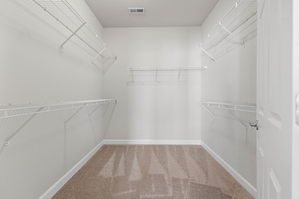 a spacious walk in closet offers lots of room for extra storage