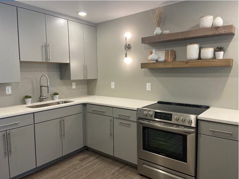 a kitchen with stainless steel appliances and white cabinets