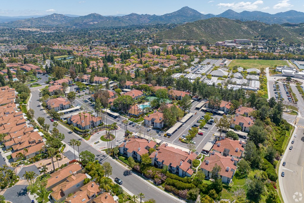 an aerial view of a neighborhood with houses and trees and mountains in the background at La Serena, San Diego