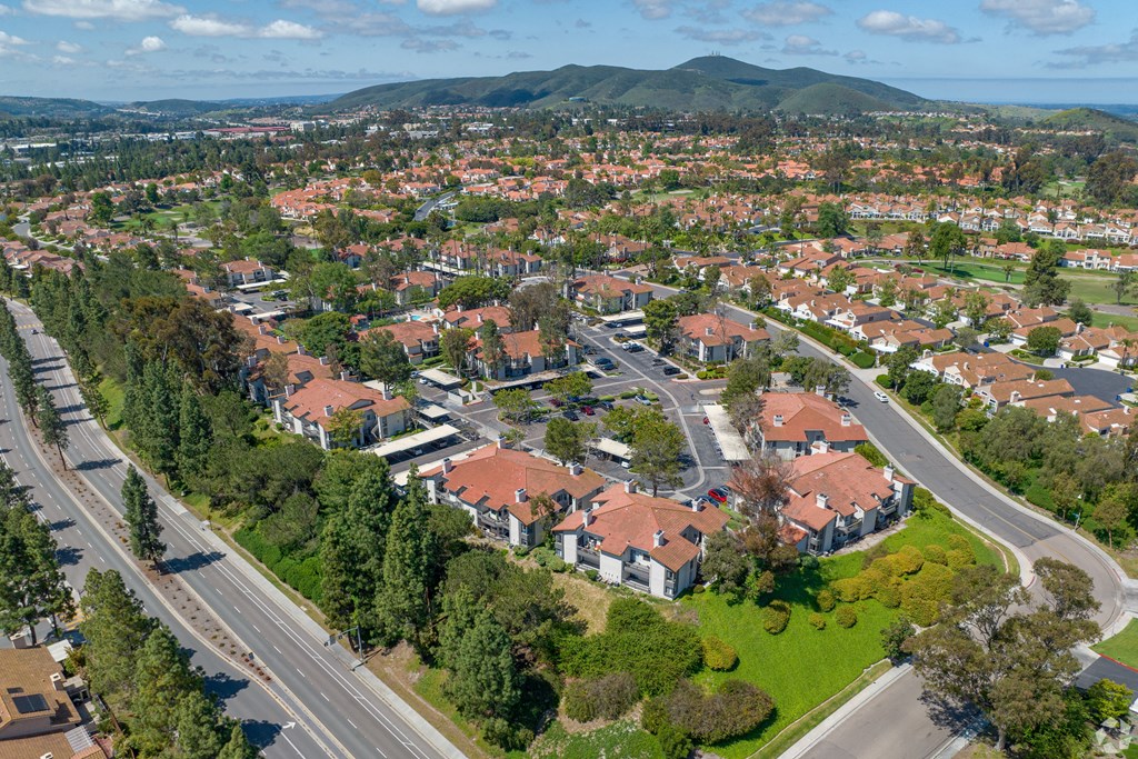 an aerial view of a neighborhood with red roofs and green grass at La Serena, San Diego, California
