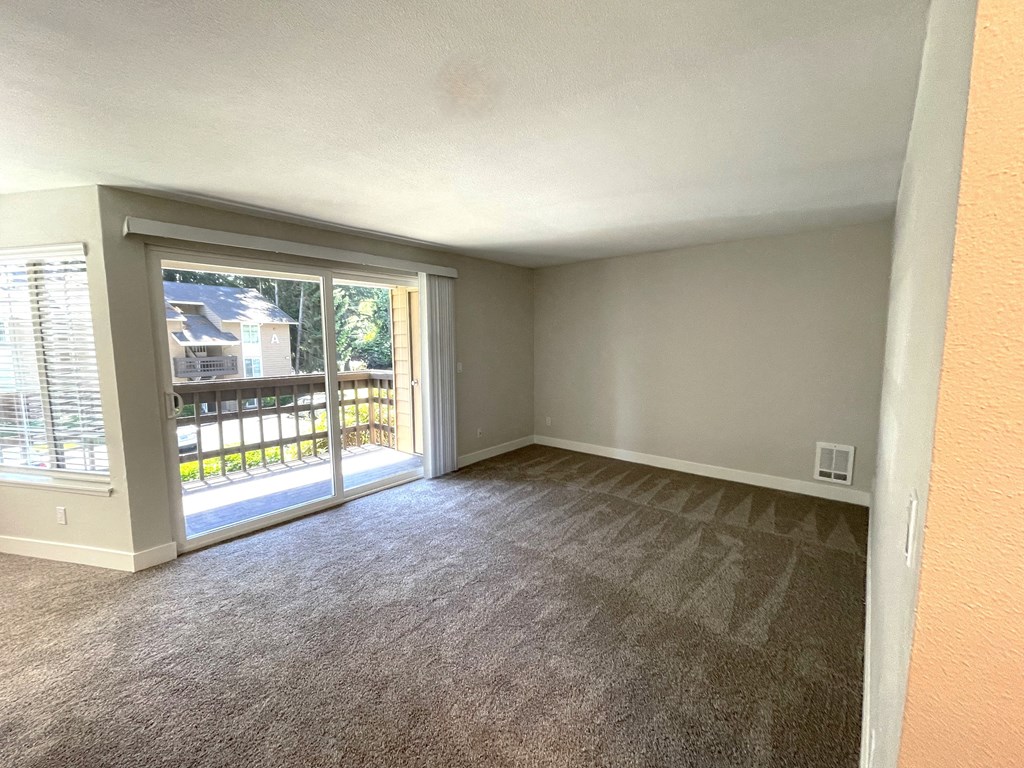 an empty living room with a patio door