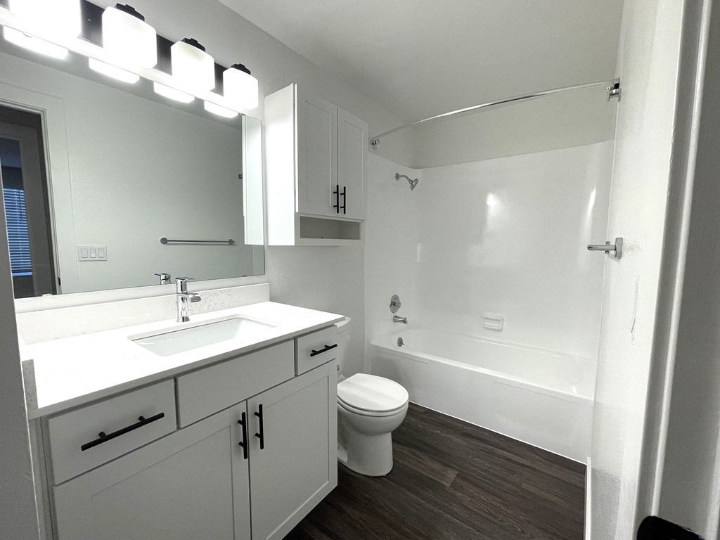 an empty bathroom with a sink toilet and shower