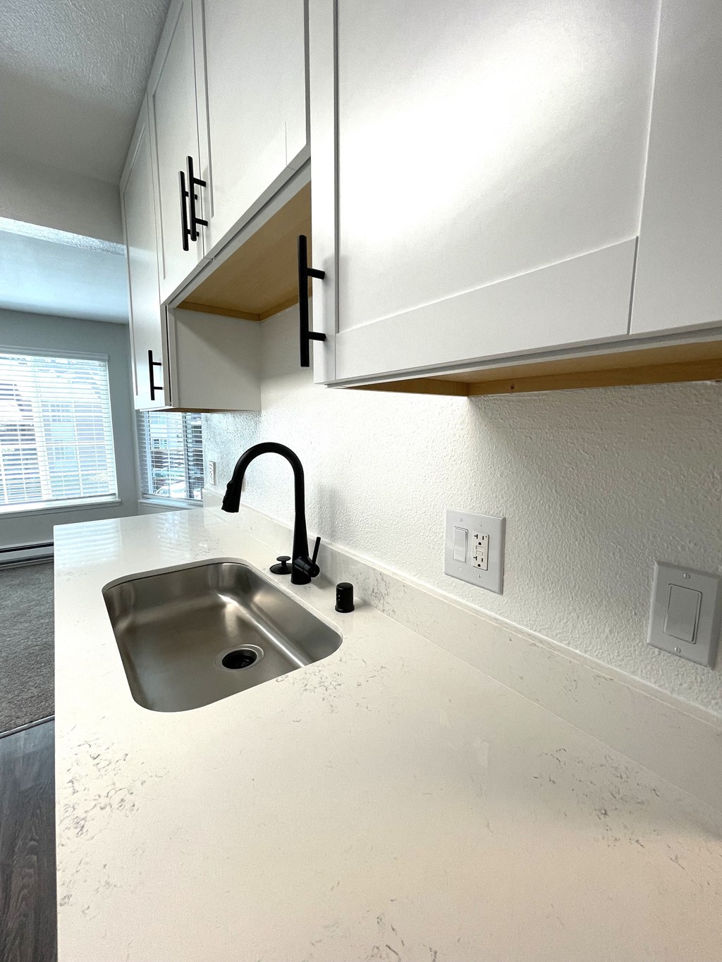 a kitchen with white cabinets and a sink