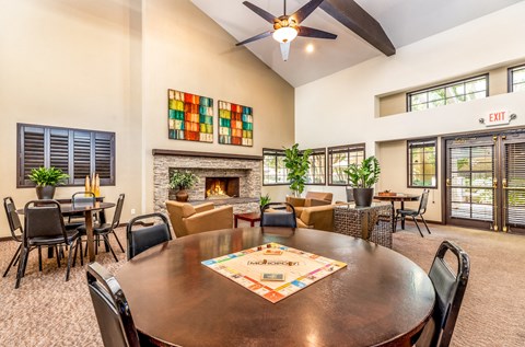 a living room with a large table and a fireplace