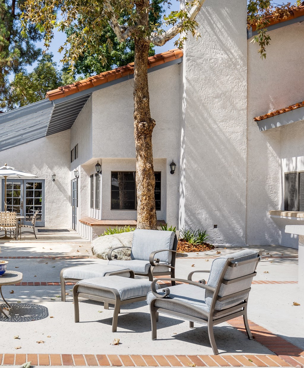 a patio with two chairs and a table