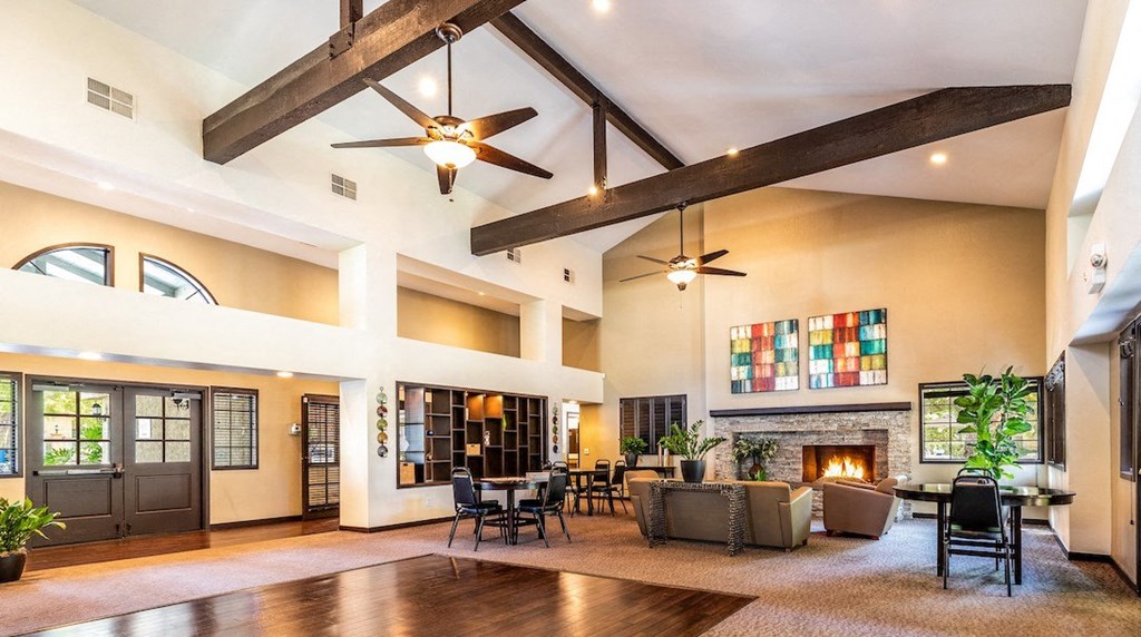 a large living room with a fireplace and a colorful painting on the wall