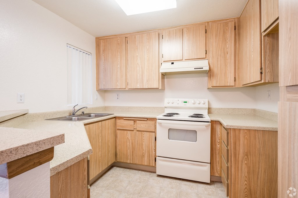 a kitchen with wooden cabinets and white appliances