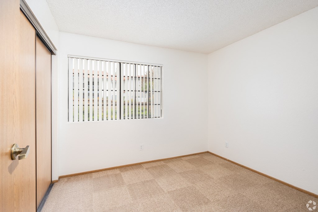 a bedroom with a door and a window