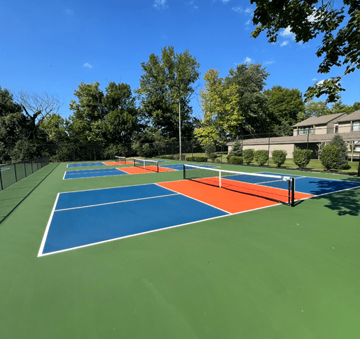 a tennis court with four different courts on it on a sunny day