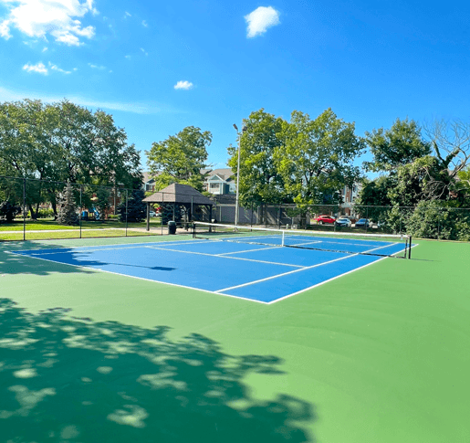a blue and green tennis court with a black scoreboard