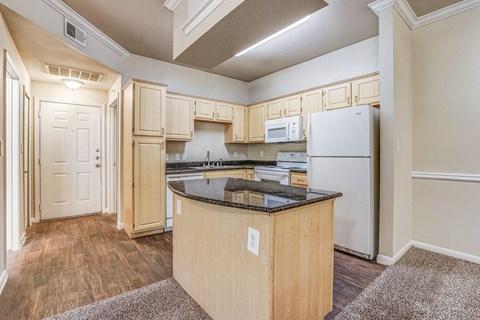 a kitchen with an island and a white refrigerator