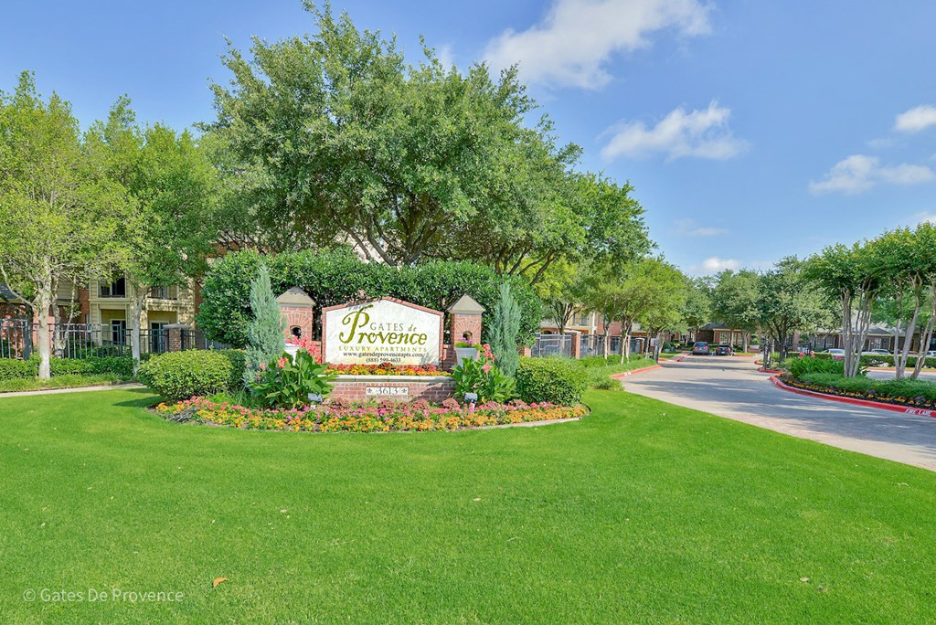 Stone property sign at Gates de Provence Apartments, Dallas 75287