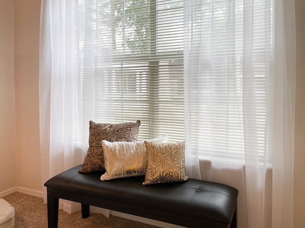 Large window with a bench at Greenbriar Apartments, Oklahoma