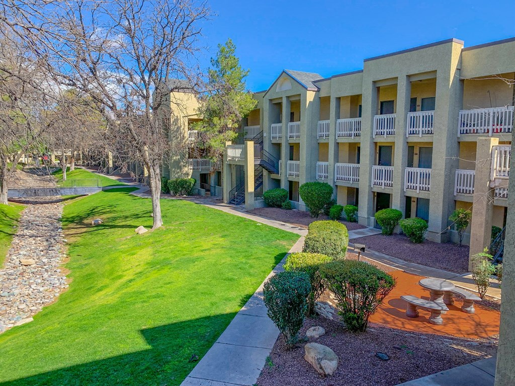 Apartment Exterior with a yard and grassApartment Exterior with a yard and grass at Pavilions at Pantano Apartments, Arizona