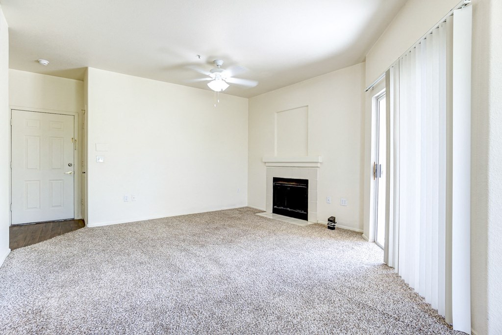 A living room with a fireplace and a carpet. at Ventana, Scottsdale