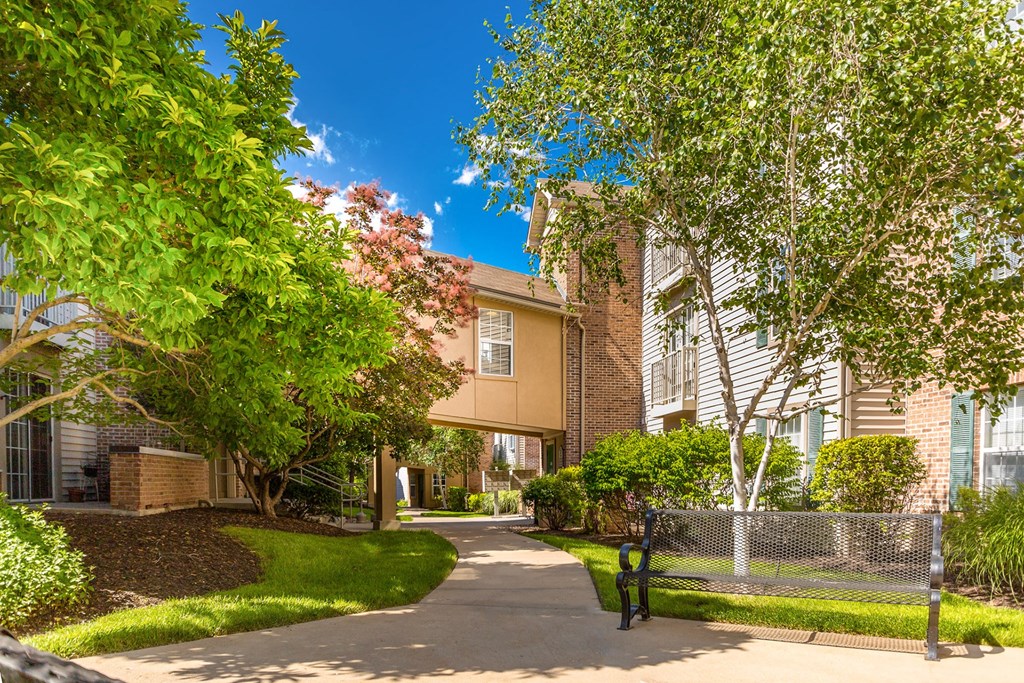 A residential area with a building and a tree at Prairie Commons - 55+ Senior Community Apartments, Lawrence, KS, 66049