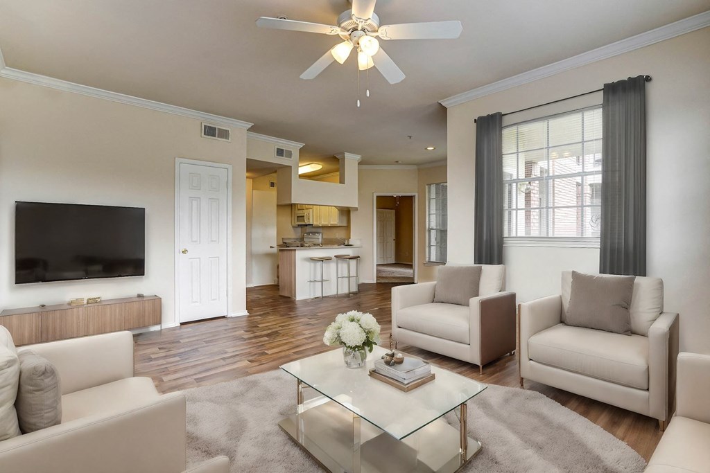 Light and bright living rooms with wood flooring at Turnberry Isle Apartment Homes, Dallas, Texas