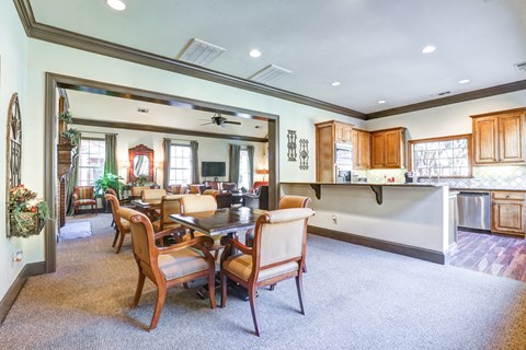 a living room with a dining room table and a kitchen